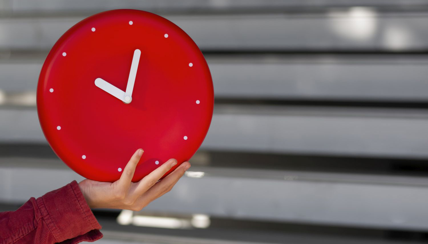 Red watch held in hand